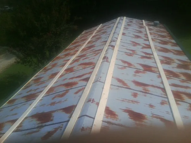 Rusted metal roof panels with new wood purlins before replacement — Storm Damage Roof Repair in Greeleyville by Roofing Brothers