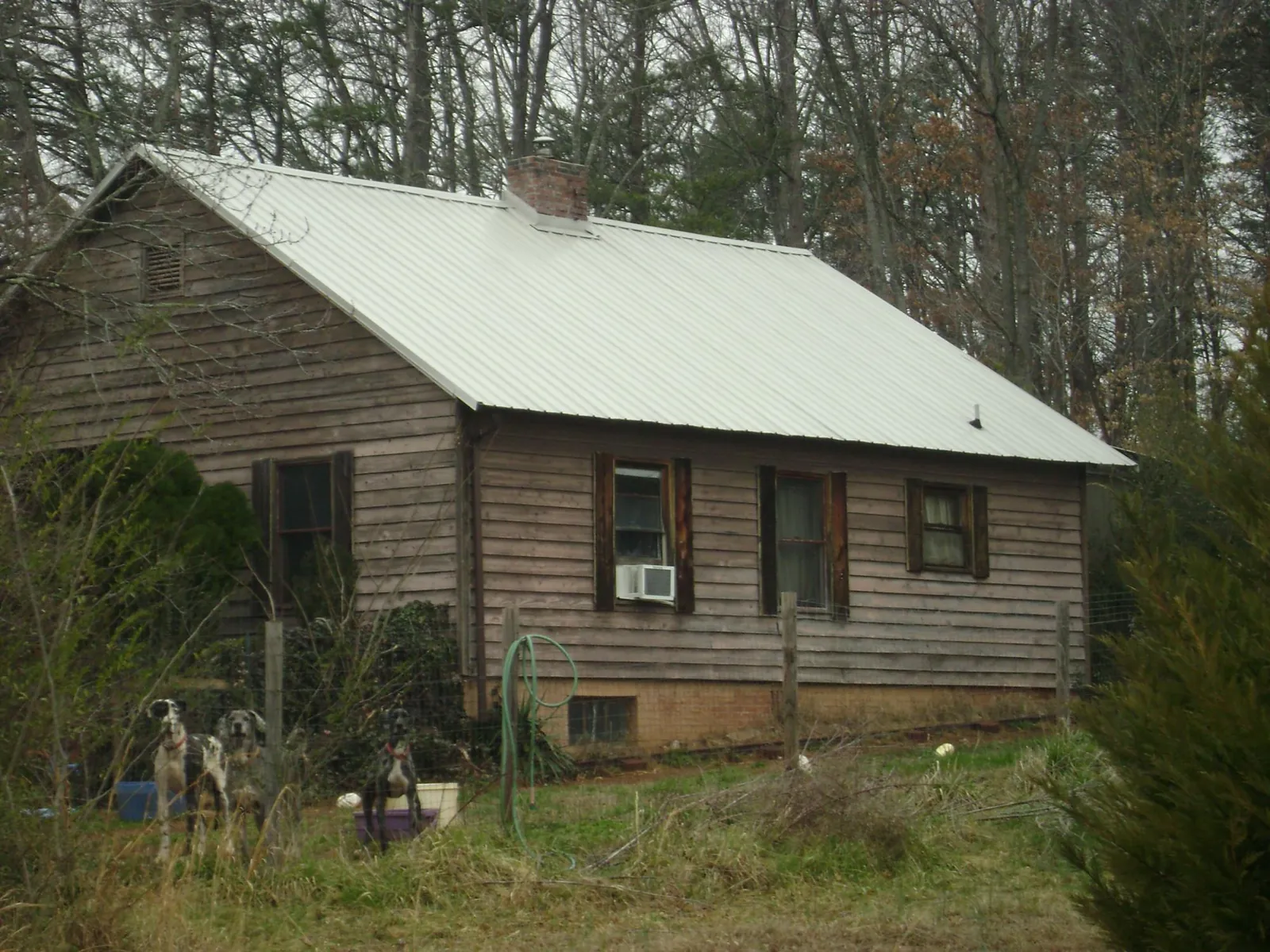 White metal roof on an old wood sided farmhouse, from a Metal Roof Installation job in Greeleyville
